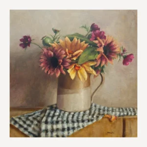 Sunflowers and cosmos with green leaves in a rustic vase on a table with a blue and white teatowel